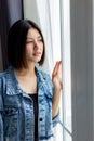 Portrait beautiful young asian woman. Pretty asian girl looks outside window and looking to nice view at house with happy time. Go Royalty Free Stock Photo