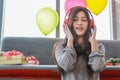 Portrait of beautiful young asian woman with  red headphone singing and enjoy with music in the living room with couch, party Royalty Free Stock Photo