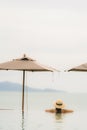 Portrait beautiful young asian woman relax in luxury outdoor swimming pool in hotel resort nearly beach sea ocean Royalty Free Stock Photo