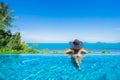 Portrait beautiful young asian woman relax in luxury outdoor swimming pool in hotel resort nearly beach sea ocean Royalty Free Stock Photo