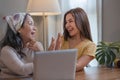 Portrait of a beautiful young Asian woman smiling and hugging her middle aged mom or grandmother, spending time at home Royalty Free Stock Photo