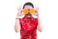 Portrait of Beautiful Young asian woman wear chinese dress traditional cheongsam or qipao. holding orange slices in front of her Royalty Free Stock Photo