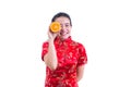 Portrait of Beautiful Young asian woman wear chinese dress traditional cheongsam. holding orange slices in front of her eye Royalty Free Stock Photo