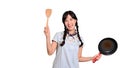 Portrait of beautiful young asian woman wear denim dress with black pan and spatula on white isolated background Royalty Free Stock Photo