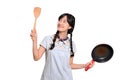 Portrait of beautiful young asian woman wear denim dress with black pan and spatula on white isolated background Royalty Free Stock Photo