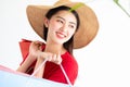 Portrait of beautiful young asian woman wearing red long dress  holding shopping bags isolated over white background. Royalty Free Stock Photo