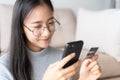 Portrait of Beautiful young Asian women are buying  online with a credit card. asia girl are using smartphone and making online Royalty Free Stock Photo