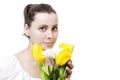 Portrait of beautiful young attractive brunette woman with spring bouquet of yellow and white flowers tulips Royalty Free Stock Photo