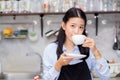 Portrait of beautiful young barista drinking a cup of coffee Royalty Free Stock Photo
