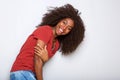 Beautiful young black woman laughing against white wall Royalty Free Stock Photo