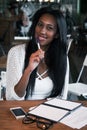 Portrait of beautiful young black woman sitting at cafe and writing notes, lifestyle concept Royalty Free Stock Photo