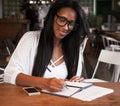 Young black woman sitting at cafe and writing notes, lifestyle concept Royalty Free Stock Photo