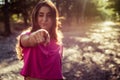 Portrait of beautiful young blinking woman against the sun background Royalty Free Stock Photo