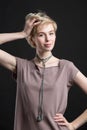 Portrait of a beautiful young blond woman wearing fashion statement necklace Royalty Free Stock Photo