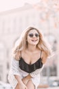 Portrait Beautiful young blonde girl in sunglasses with puffy lips and feminine body posing on the street style on sunny Royalty Free Stock Photo