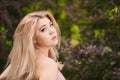 Beautiful young blonde girl in sunglasses with puffy lips and feminine body posing on the street style on sunny day