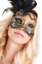 Portrait of Beautiful young blonde woman in black and gold mysterious venetian mask. Fashion photo on white background Royalty Free Stock Photo