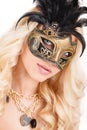 Portrait of Beautiful young blonde woman in black and gold mysterious venetian mask. Fashion photo on white background Royalty Free Stock Photo