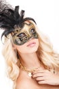 Portrait of Beautiful young blonde woman in black and gold mysterious venetian mask. Fashion photo on white background Royalty Free Stock Photo