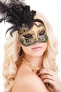 Portrait of Beautiful young blonde woman in black and gold mysterious venetian mask. Fashion photo on white background Royalty Free Stock Photo