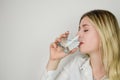 Portrait of a beautiful young blonde woman drinking a glass of water Royalty Free Stock Photo