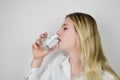 Portrait of a beautiful young blonde woman drinking a glass of water Royalty Free Stock Photo
