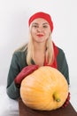Portrait of beautiful young blonde woman with pumpkin ready for halloween celebration, mockup for postcard and invitation or adver