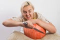 Portrait of beautiful young blonde woman with pumpkin ready for halloween celebration, mockup for postcard and invitation or adver