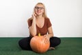 Portrait of beautiful young blonde woman with pumpkin ready for halloween celebration, mockup for postcard and invitation or adver