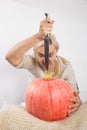 Portrait of beautiful young blonde woman with pumpkin ready for halloween celebration, mockup for postcard and invitation or adver
