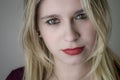 Portrait of a beautiful young blonde woman with red lipstick and intense gaze Royalty Free Stock Photo