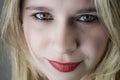Portrait of a beautiful young blonde woman with red lipstick and intense gaze Royalty Free Stock Photo