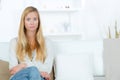 Portrait beautiful young blonde woman sitting on sofa Royalty Free Stock Photo