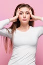 Portrait of beautiful young brunette with bare shoulders touching her temples feeling stress Royalty Free Stock Photo