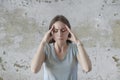 Portrait of beautiful young brunette touching her temples feeling stress Royalty Free Stock Photo