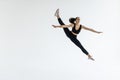 The portrait of beautiful young brunette woman gymnast training calilisthenics exercise with acrobatic element on white studio Royalty Free Stock Photo