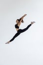 The portrait of beautiful young brunette woman gymnast training calilisthenics exercise with acrobatic element on white studio Royalty Free Stock Photo