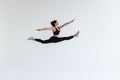 The portrait of beautiful young brunette woman gymnast training calilisthenics exercise with acrobatic element on white studio Royalty Free Stock Photo