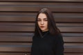 Portrait of a beautiful young brunette woman with natural make-up with beautiful brown eyes in a black stylish sweater Royalty Free Stock Photo