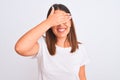 Portrait of beautiful and young brunette woman standing over isolated white background smiling and laughing with hand on face Royalty Free Stock Photo