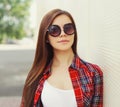 Portrait beautiful young brunette woman wearing a sunglasses in a city on white background Royalty Free Stock Photo
