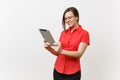 Portrait of beautiful young business teacher woman user in red shirt, glasses working typing on tablet pc computer