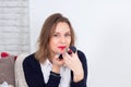 Portrait of Beautiful Young Business Woman with Blond Hair Putting Red Lipstick While Looking at the Camera with Smile. Royalty Free Stock Photo