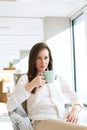 Portrait of beautiful young businesswoman drinking coffee in new office Royalty Free Stock Photo