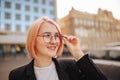 Portrait of beautiful young businesswoman outdoor over blurred street background. Closeup lifestyle portrait. Royalty Free Stock Photo