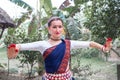 Portrait of beautiful young Caucasian classical odissi dancer wears traditional costume and posing Odissi dance mudra in the