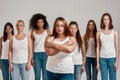 Portrait of beautiful young caucasian plus size woman in white shirt with crossed arms looking at camera. Group of Royalty Free Stock Photo