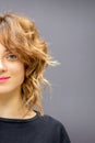 Portrait of a beautiful young caucasian red-haired woman with short wavy hairstyle smiling and looking at camera on dark Royalty Free Stock Photo