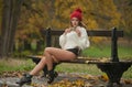 Portrait of a beautiful young Caucasian sensual woman with a red cap ,white pullover and black boots in autumn park Royalty Free Stock Photo