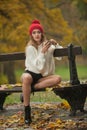 Portrait of a beautiful young Caucasian sensual woman with a red cap ,white pullover and black boots in autumn park Royalty Free Stock Photo